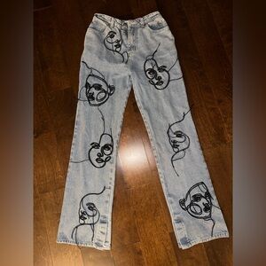 Maniere De Voir Light Blue Flare Jeans with Black Abstract Face Embroidery
